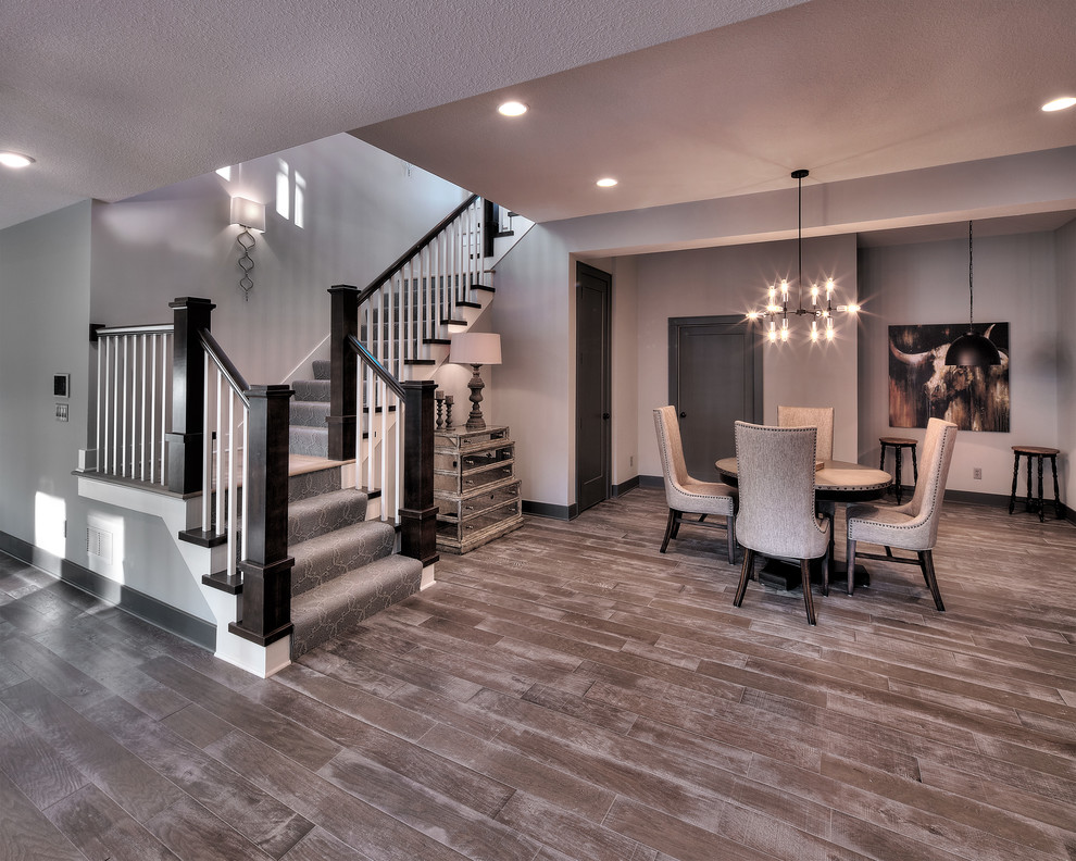This is an example of a medium sized nautical walk-out basement in Dallas with grey walls, light hardwood flooring, no fireplace and beige floors.