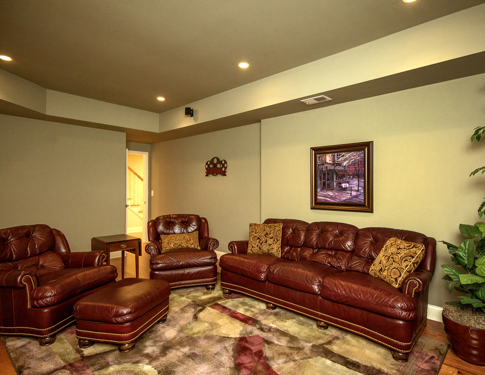 This is an example of a medium sized classic walk-out basement in Atlanta with beige walls, dark hardwood flooring and no fireplace.