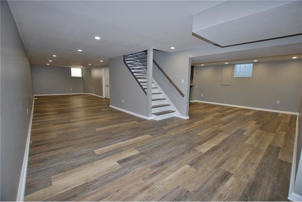 Photo of a medium sized traditional fully buried basement in Indianapolis with grey walls, vinyl flooring and brown floors.