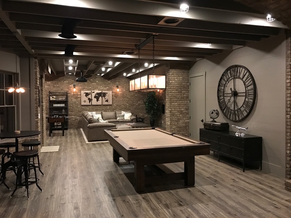Urban look-out medium tone wood floor and brown floor basement photo in Atlanta with brown walls and no fireplace