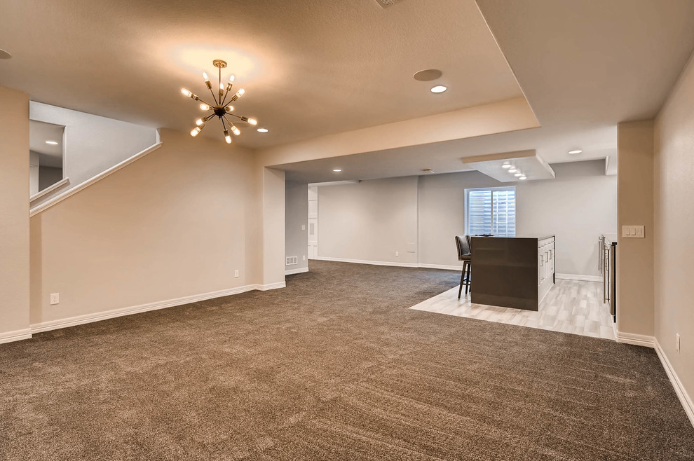 Example of a large underground carpeted and brown floor basement design in Denver with white walls and no fireplace