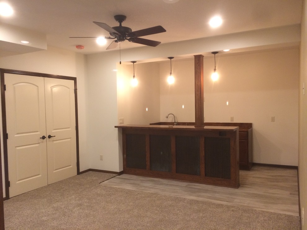Basement - mid-sized craftsman underground carpeted basement idea in Other with beige walls and no fireplace