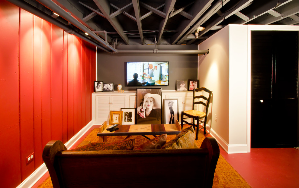 ワシントンD.C.にある低価格の中くらいなエクレクティックスタイルのおしゃれな地下室 (全地下、赤い壁、コンクリートの床、暖炉なし、赤い床) の写真