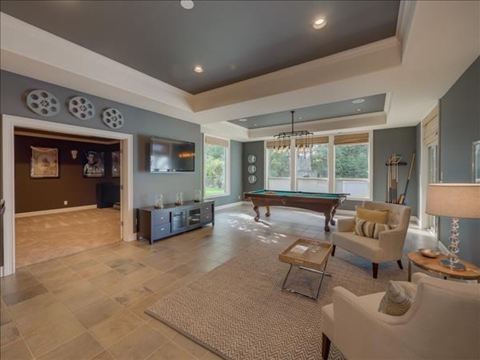 Example of a large transitional walk-out slate floor basement design in Portland with gray walls and no fireplace