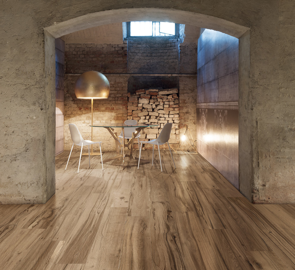 Inspiration for an industrial basement in London with grey walls and medium hardwood flooring.