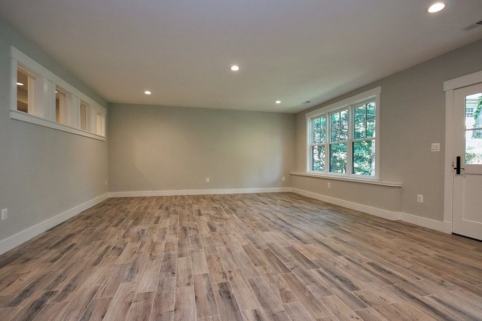 Large transitional walk-out ceramic tile and multicolored floor basement photo in DC Metro with gray walls and no fireplace