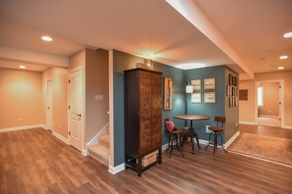 Example of a large arts and crafts look-out vinyl floor and brown floor basement design in Chicago with beige walls and no fireplace