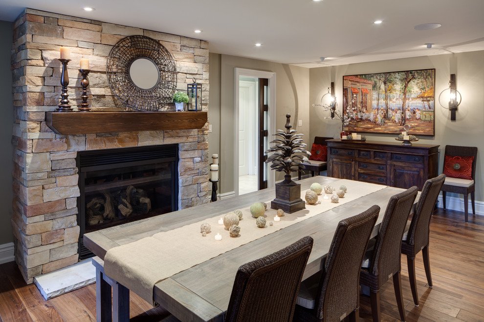 Inspiration for a transitional dark wood floor dining room remodel in Toronto with a standard fireplace and a stone fireplace