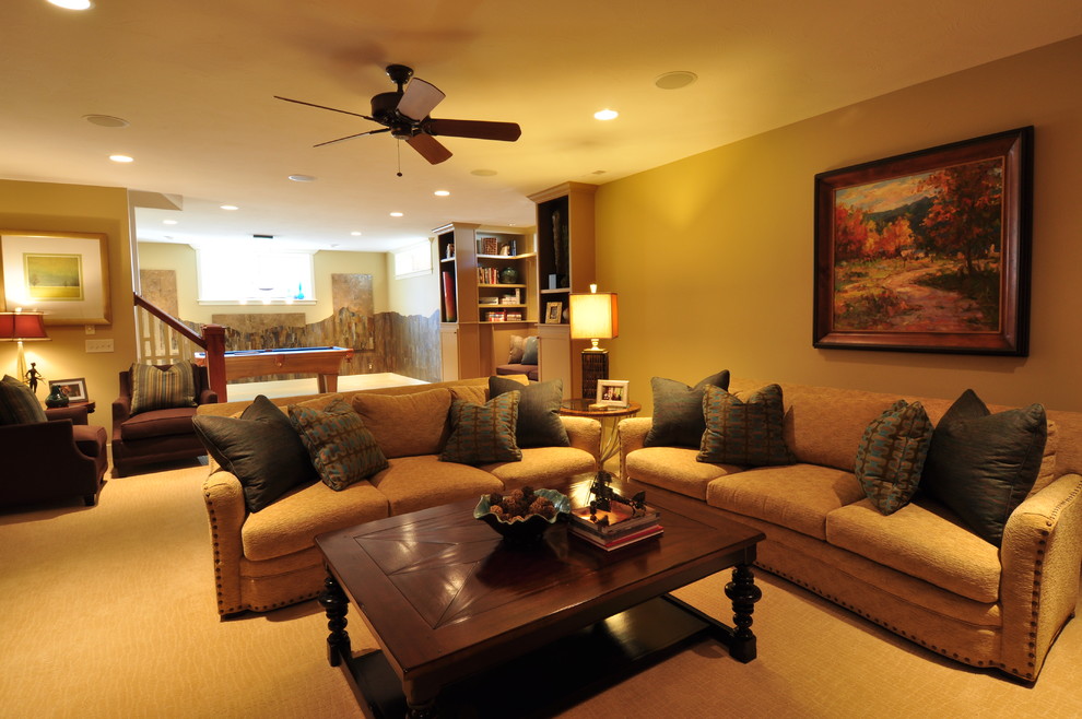 This is an example of a large contemporary fully buried basement in Omaha with beige walls, carpet and no fireplace.