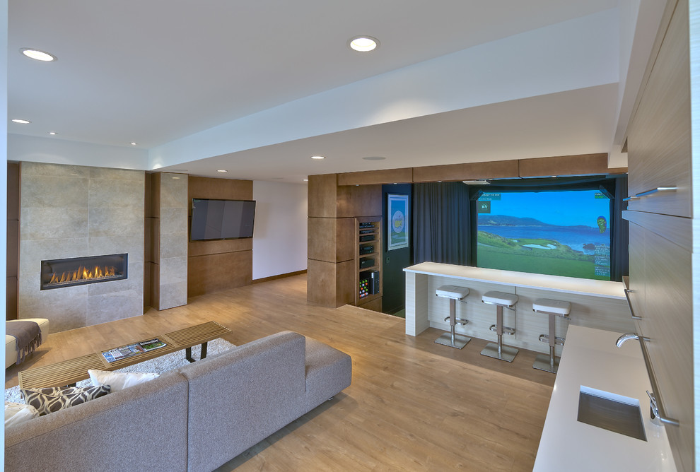 Example of a large trendy walk-out light wood floor basement design in Other with a ribbon fireplace and a tile fireplace