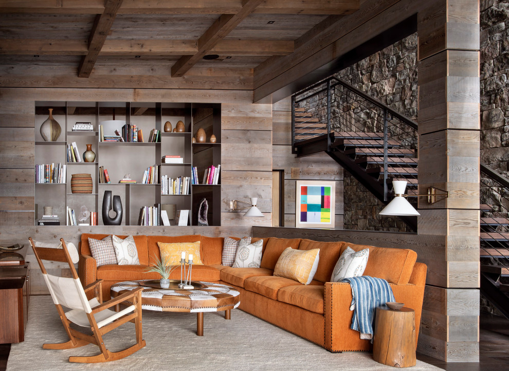 This is an example of a medium sized rustic open plan living room in Other with dark hardwood flooring, a built-in media unit, brown walls and brown floors.