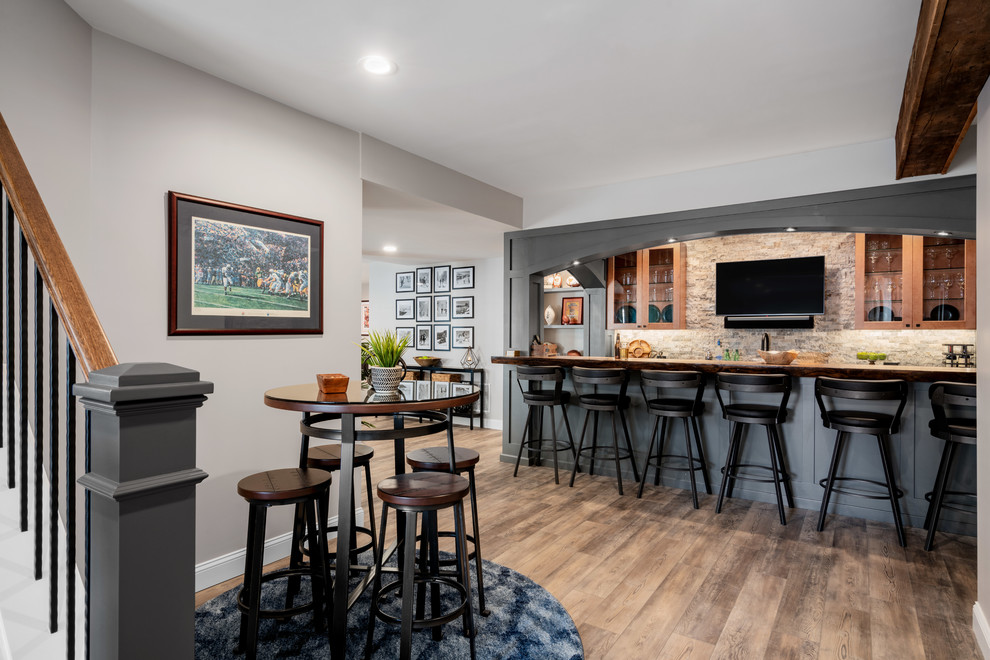 Home bar - transitional medium tone wood floor and brown floor home bar idea in Philadelphia