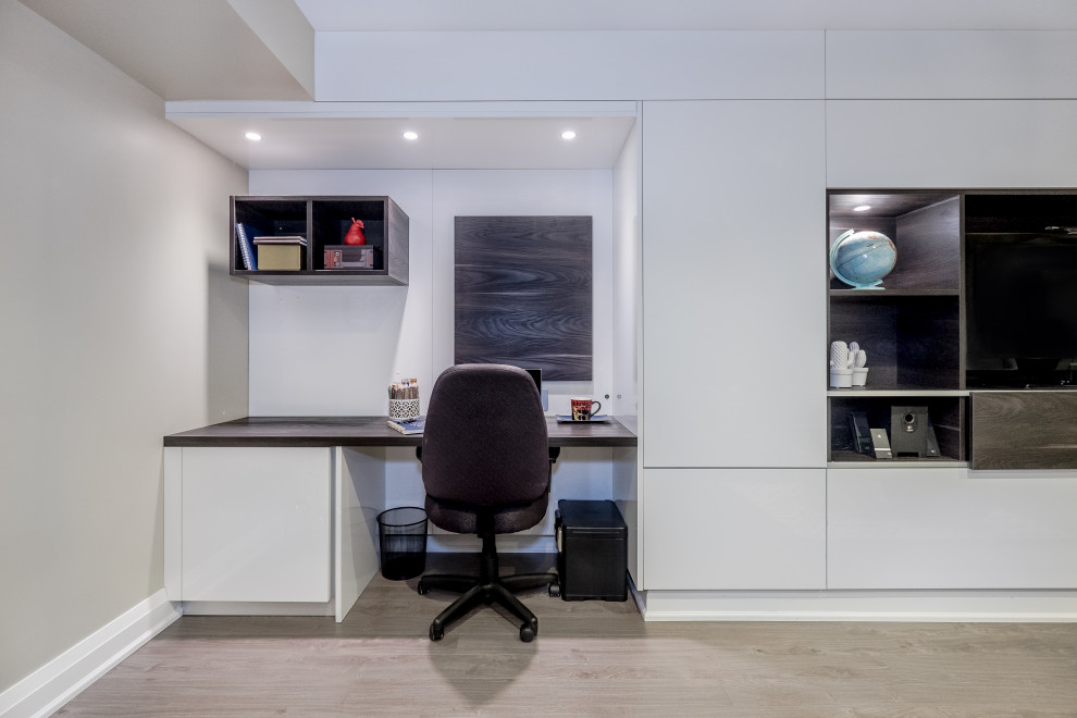 Exemple d'un petit bureau moderne avec un mur beige, sol en stratifié et un sol marron.