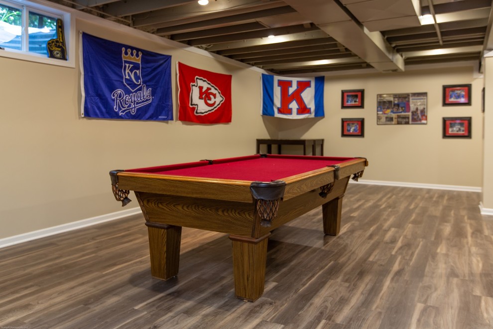 Inspiration for a large traditional fully buried basement in Kansas City with beige walls, vinyl flooring and brown floors.