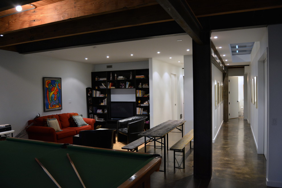 Large contemporary walk-out basement in Toronto with white walls and concrete flooring.