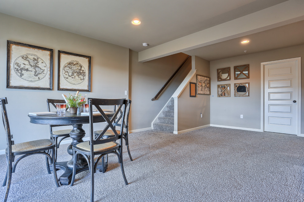 Medium sized rural walk-out basement in Chicago with grey walls and carpet.