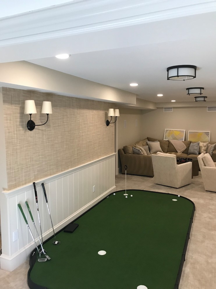 This is an example of a medium sized traditional fully buried basement in Boston with beige walls, carpet, no fireplace, grey floors and a dado rail.