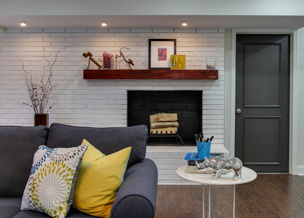 Inspiration for a mid-sized transitional walk-out dark wood floor basement remodel in Raleigh with white walls and a brick fireplace