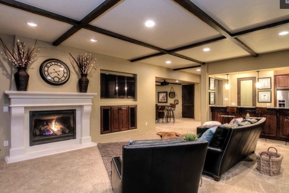 Inspiration for a large mediterranean look-out carpeted and beige floor basement remodel in Denver with beige walls and a standard fireplace