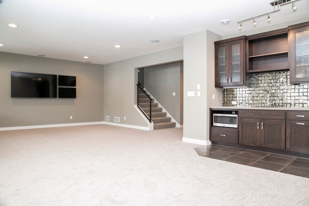 This is an example of a contemporary look-out basement in Minneapolis with grey walls, carpet and no fireplace.