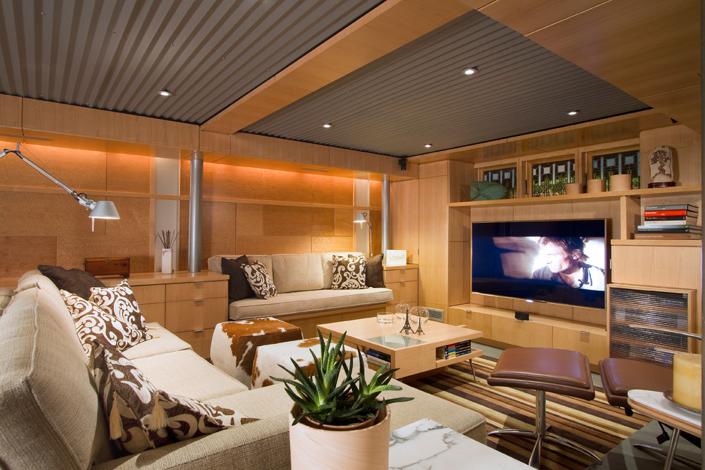 Inspiration for a mid-sized modern look-out carpeted and green floor basement remodel in Philadelphia with beige walls and no fireplace