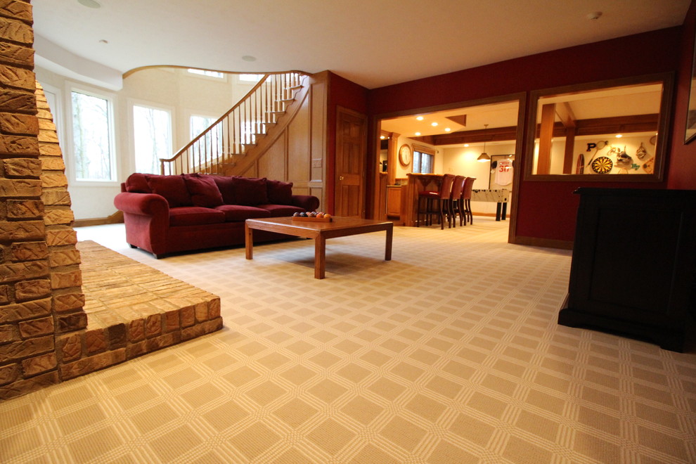 Large classic walk-out basement in Columbus with red walls, carpet, a standard fireplace and a brick fireplace surround.