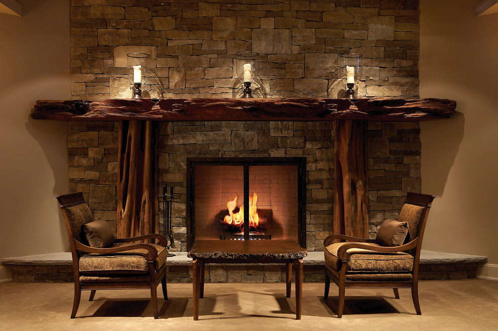 This is an example of a large rustic basement in Toronto with beige walls, carpet, a standard fireplace and a stone fireplace surround.