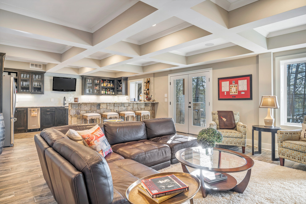 This is an example of a medium sized traditional walk-out basement in Other with beige walls, porcelain flooring, no fireplace and brown floors.