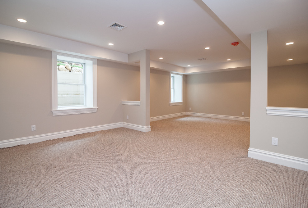 Inspiration for a medium sized contemporary look-out basement in New York with beige walls and carpet.