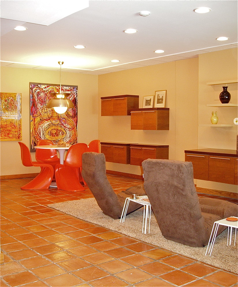 Inspiration for a large modern walk-out terra-cotta tile basement remodel in Philadelphia with yellow walls