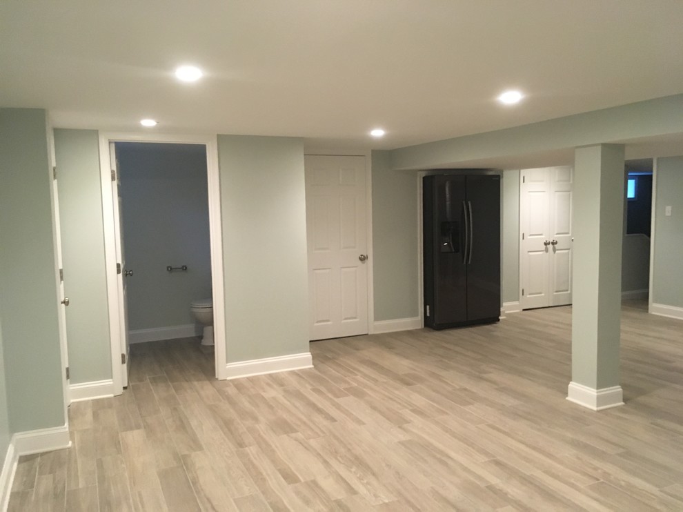 Basement - huge contemporary ceramic tile and gray floor basement idea in Philadelphia with green walls