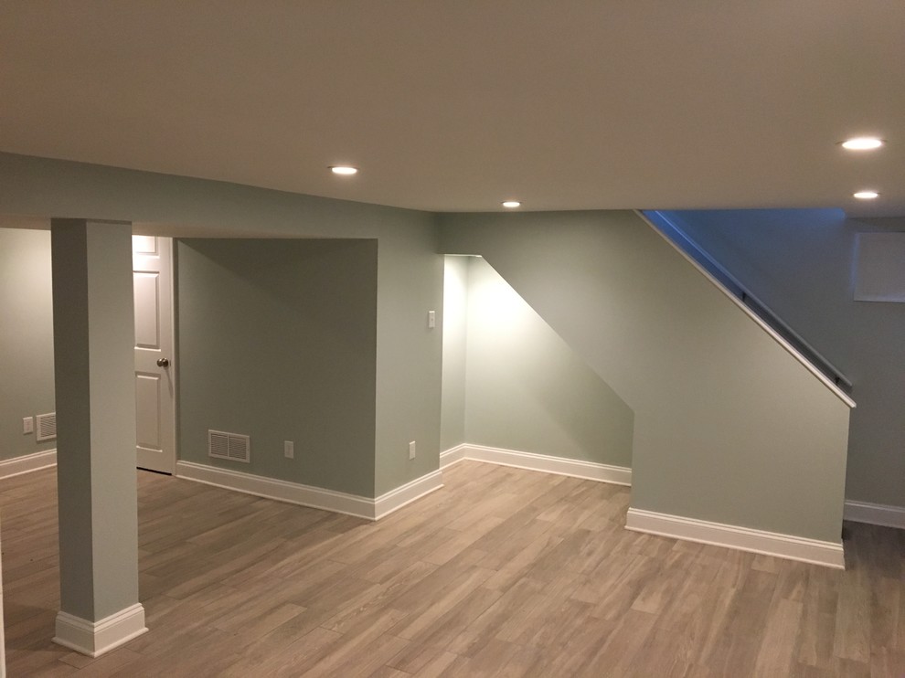Geräumiger Moderner Keller mit grüner Wandfarbe, Keramikboden und grauem Boden in Philadelphia