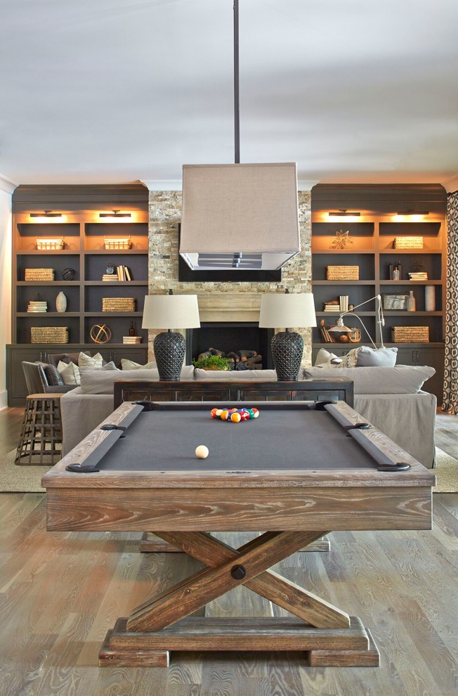 Example of a huge country walk-out medium tone wood floor basement design in Atlanta with white walls and a standard fireplace