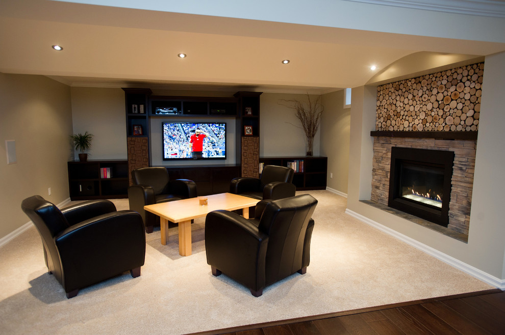 Large trendy underground medium tone wood floor basement photo in Toronto with beige walls and a standard fireplace