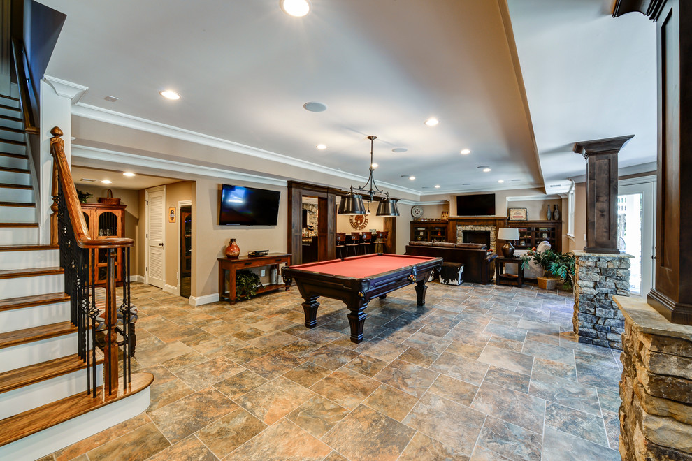 Example of a large arts and crafts walk-out porcelain tile basement design in Atlanta with a standard fireplace and a stone fireplace