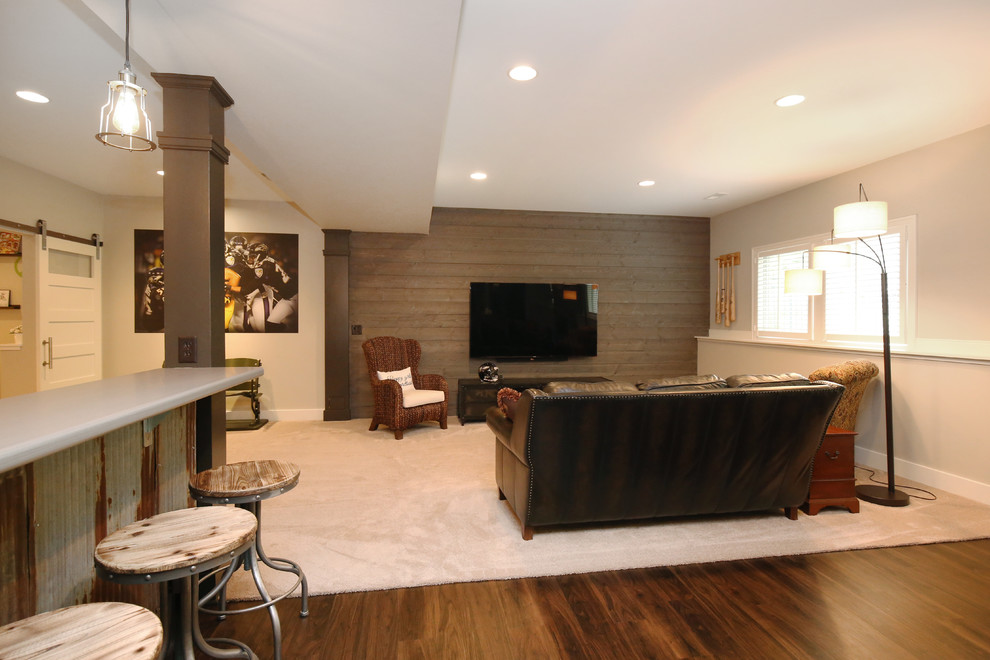 Inspiration for a large classic look-out basement in Grand Rapids with grey walls, vinyl flooring, a standard fireplace and a tiled fireplace surround.