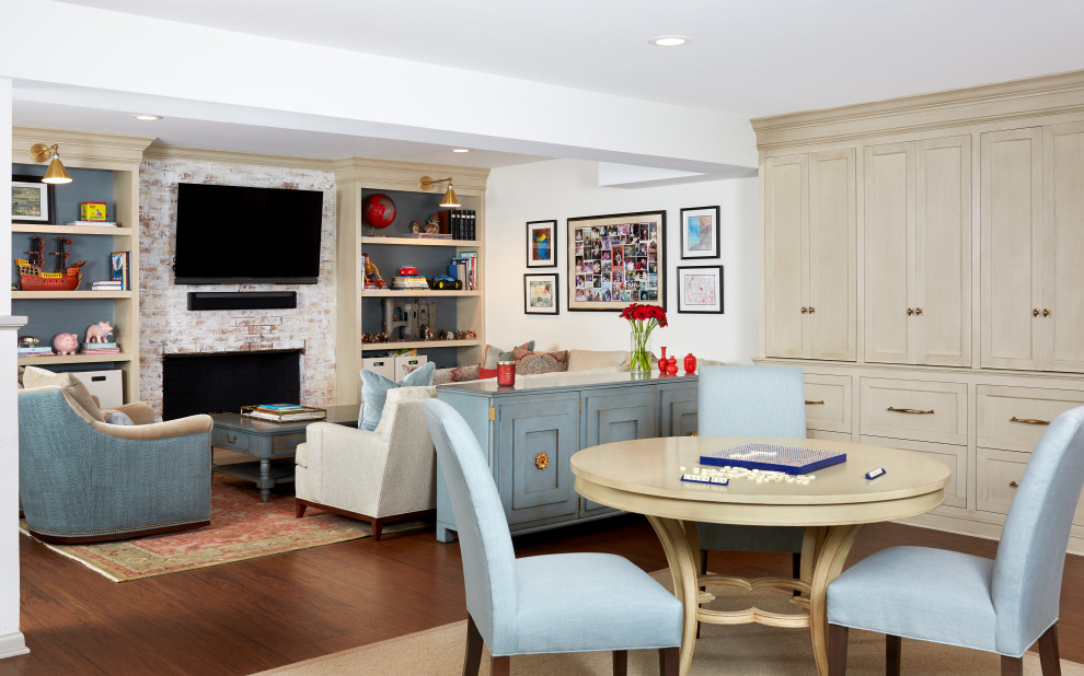 Photo of a large classic games room in DC Metro with white walls, laminate floors, a standard fireplace, a brick fireplace surround and brown floors.
