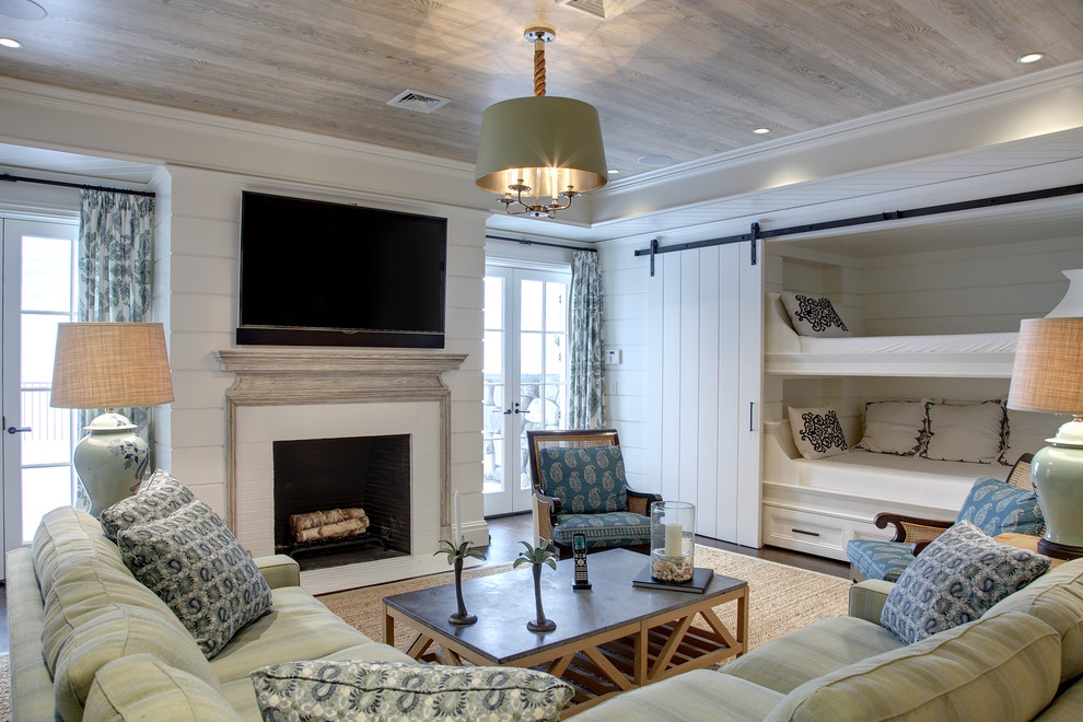 Medium sized nautical walk-out basement in New York with white walls, dark hardwood flooring, a standard fireplace, brown floors and a chimney breast.