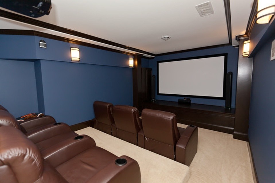 Home theater - large traditional carpeted home theater idea in Chicago with blue walls
