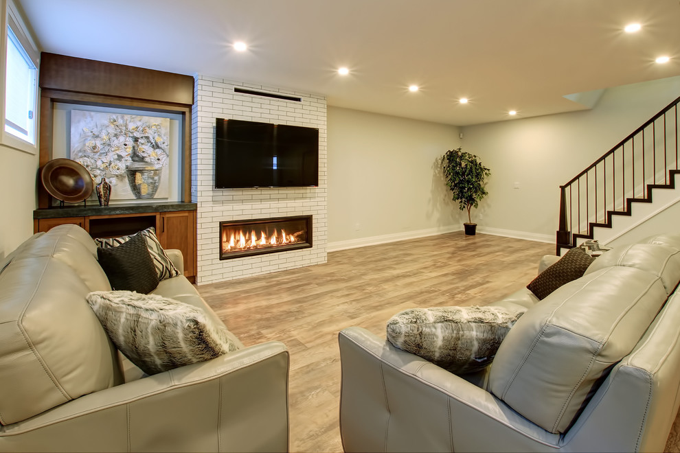 Design ideas for a medium sized traditional look-out basement in Toronto with white walls, a ribbon fireplace and a brick fireplace surround.
