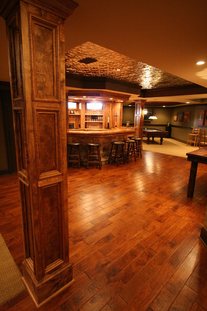 This is an example of a large rustic fully buried basement in Atlanta with medium hardwood flooring and brown floors.