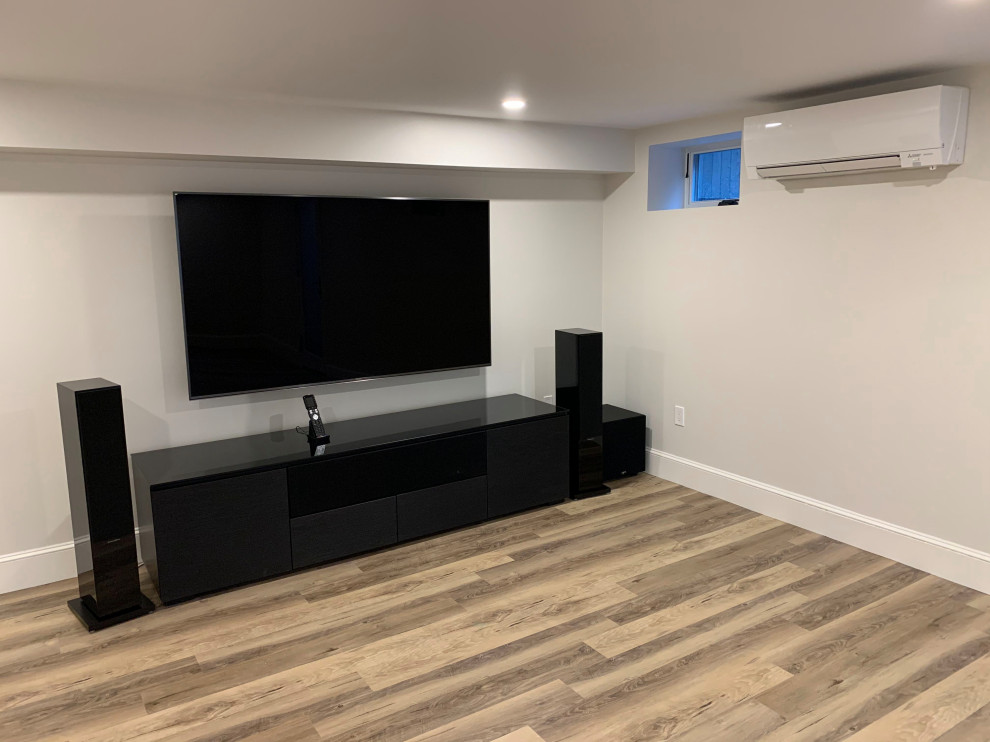 Mid-sized transitional look-out medium tone wood floor and brown floor basement photo in Boston with gray walls and no fireplace