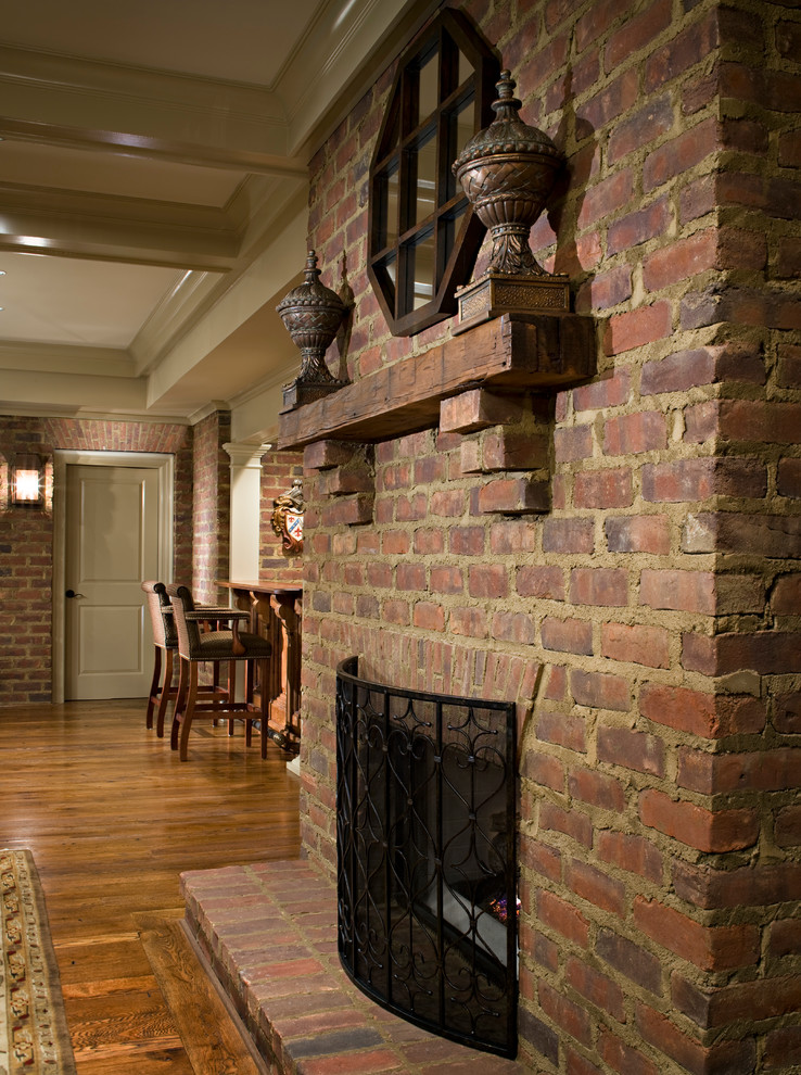 Inspiration for a timeless medium tone wood floor basement remodel in Atlanta with a standard fireplace and a brick fireplace