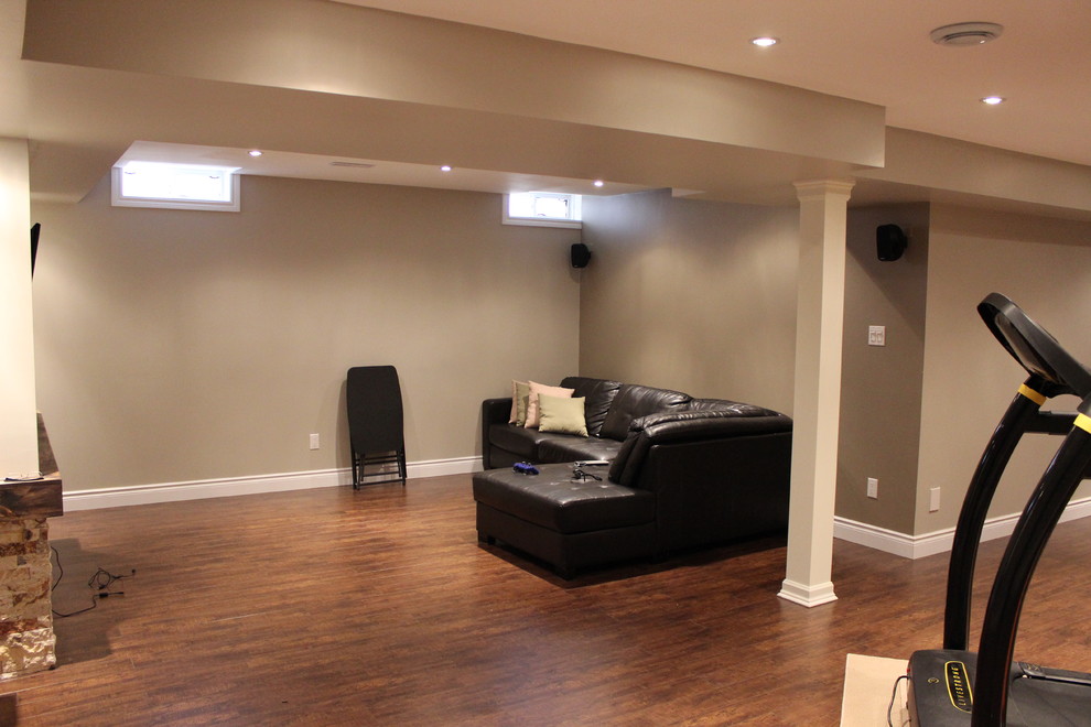 Design ideas for a large modern look-out basement in Toronto with grey walls and laminate floors.