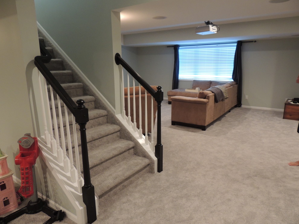Inspiration for a mid-sized timeless look-out carpeted basement remodel in Detroit with gray walls and no fireplace