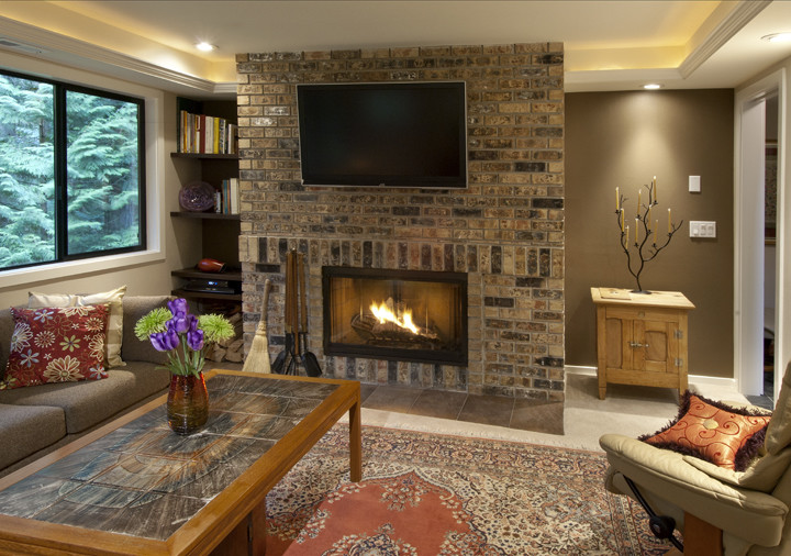 Example of a trendy look-out carpeted basement design in Seattle with brown walls, a standard fireplace and a brick fireplace