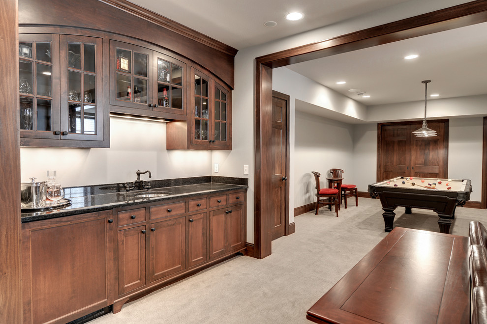 This is an example of a traditional home bar in Minneapolis with carpet and grey floors.