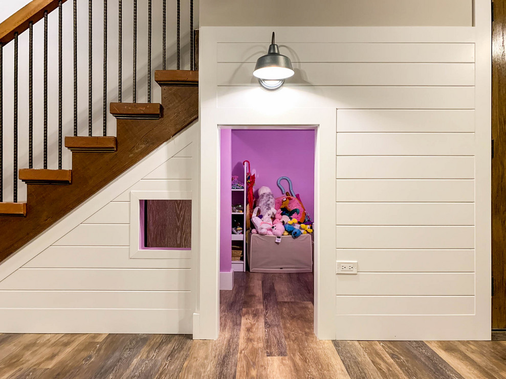 This is an example of a large rural walk-out basement in Chicago with beige walls, vinyl flooring and brown floors.