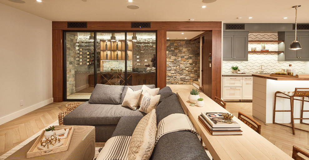 Traditional basement in Los Angeles with beige walls, light hardwood flooring and beige floors.