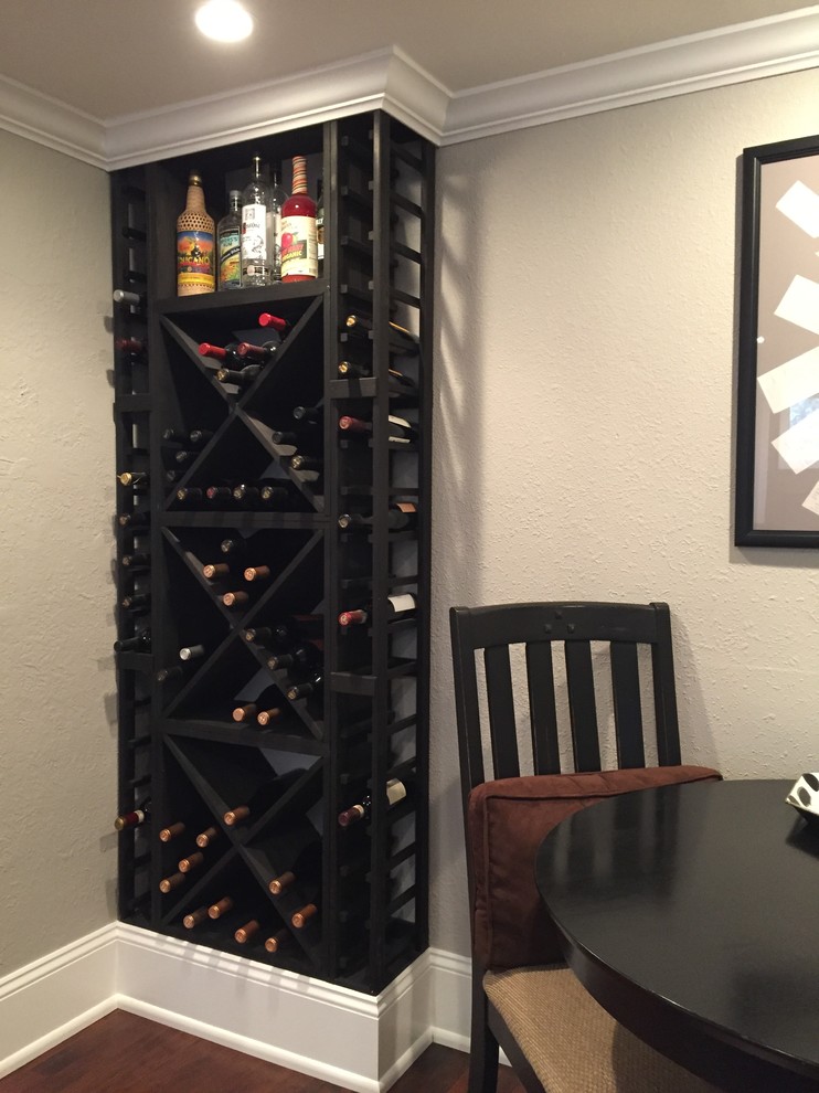 Wine cellar - mid-sized rustic dark wood floor and brown floor wine cellar idea in Denver